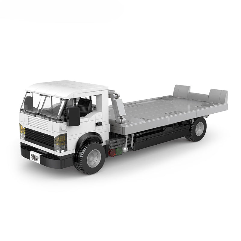 Model truck made of interlocking bricks on a white background