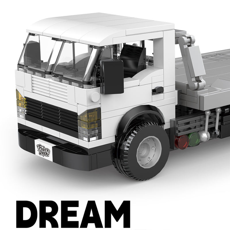 Model truck made of interlocking bricks with 'DREAM' text below on a white background