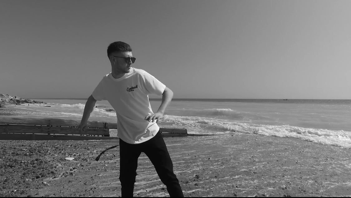 Contrast Clothing Worthing seafront white tee on the beach streetwear